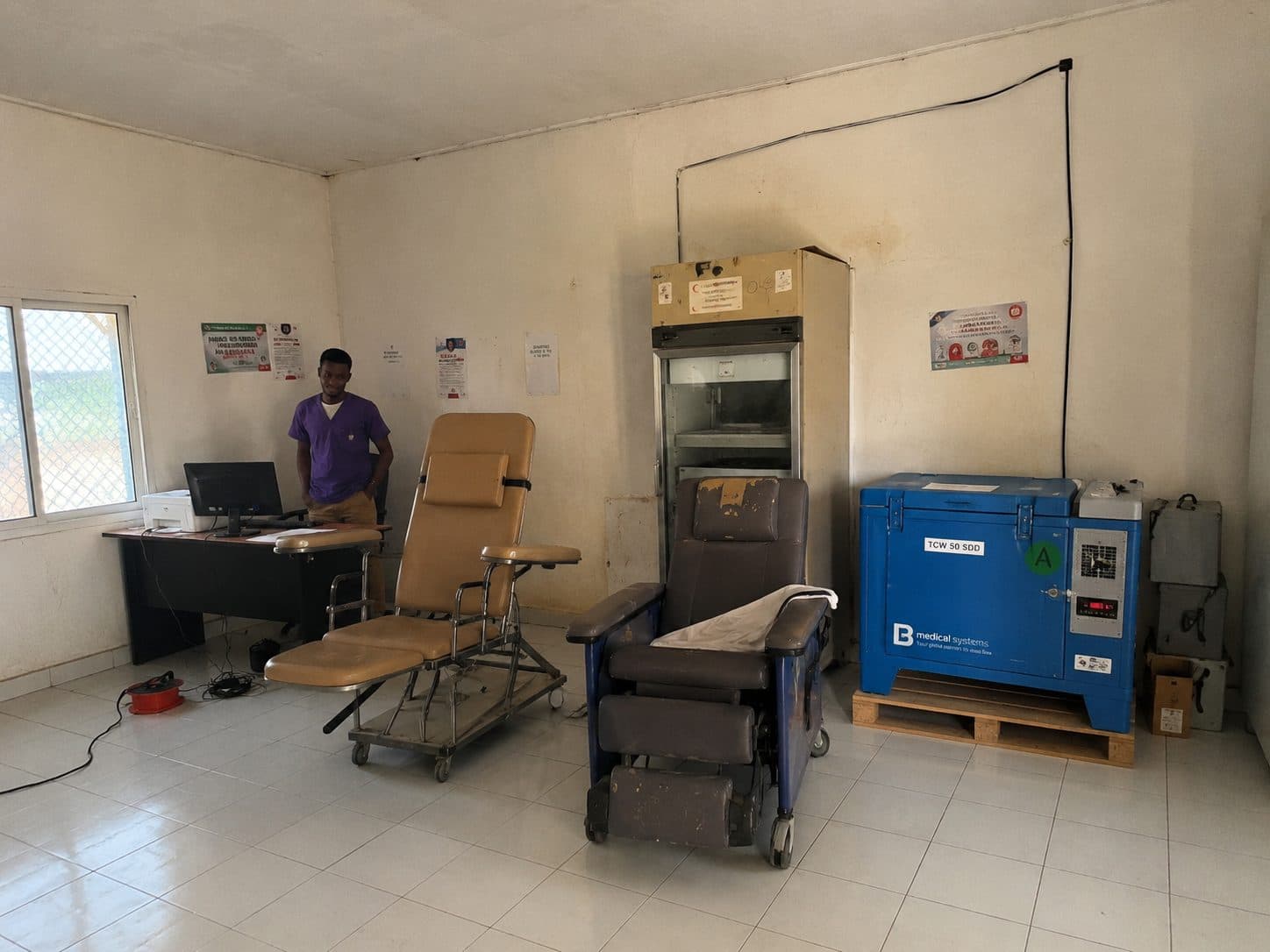 A consulting room with a treatment chair and newly delivered diagnostic equipment