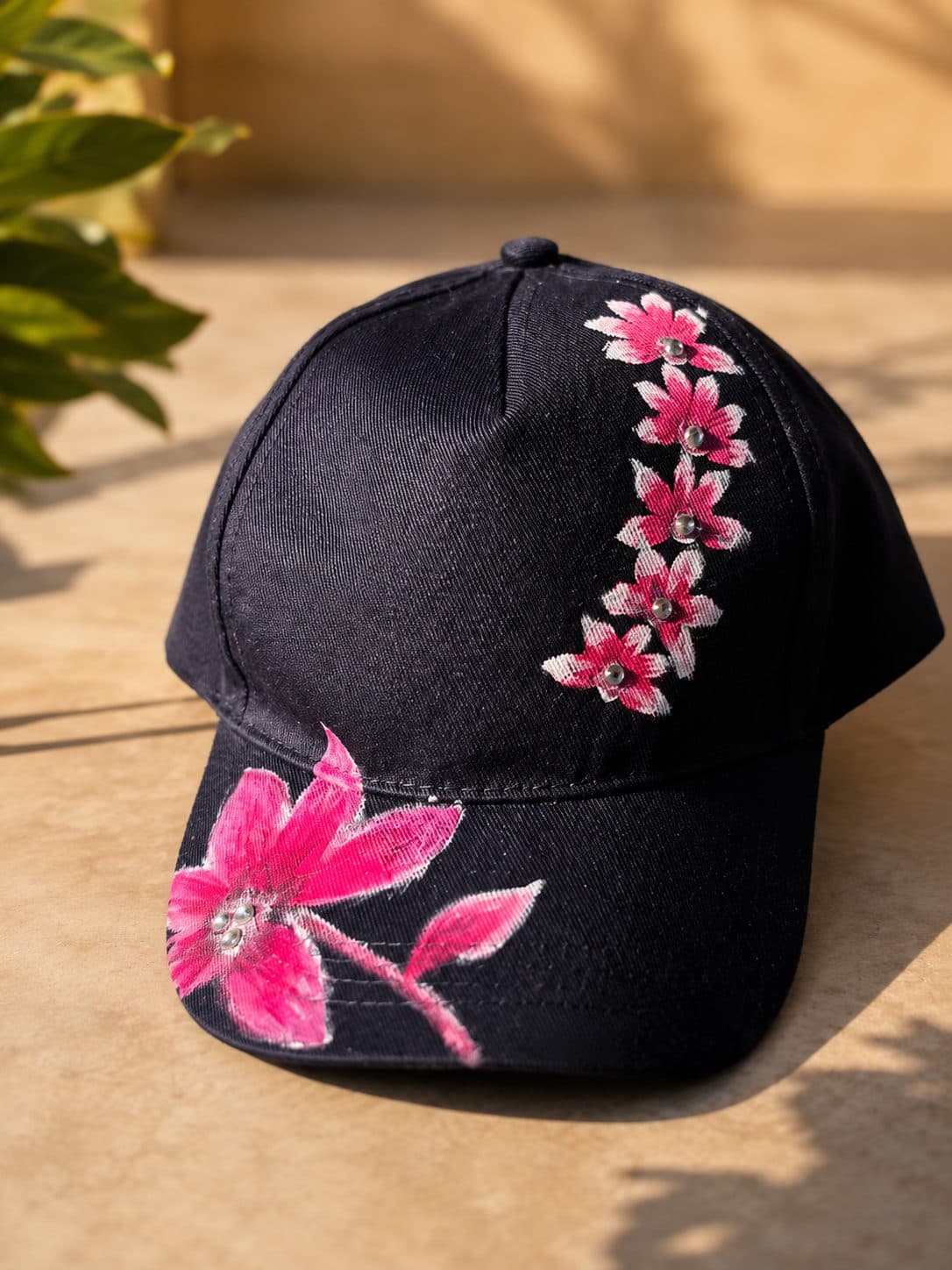 A cap hand-embroidered with pink flowers